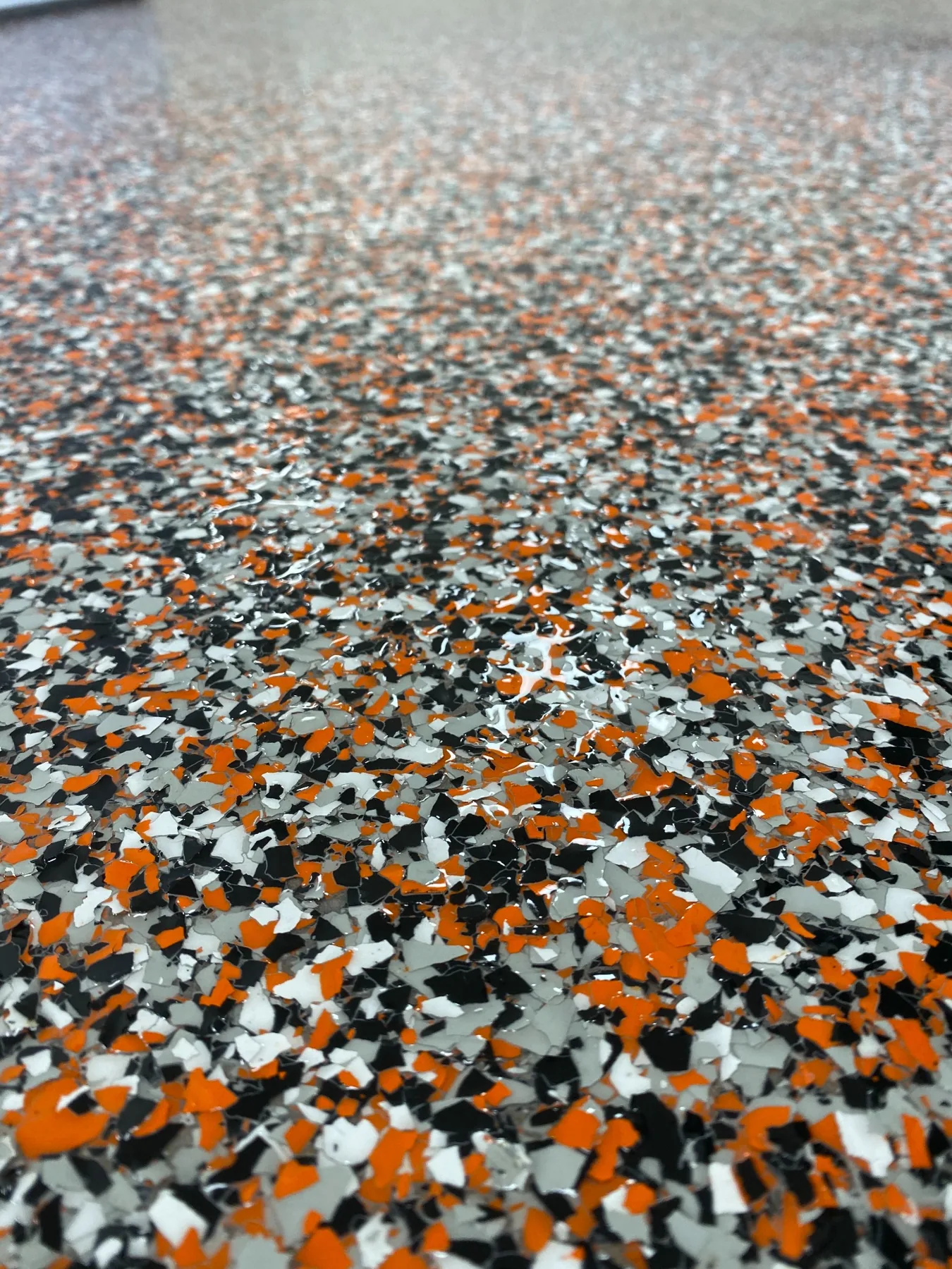 Orange, black and white epoxy flake floor detail