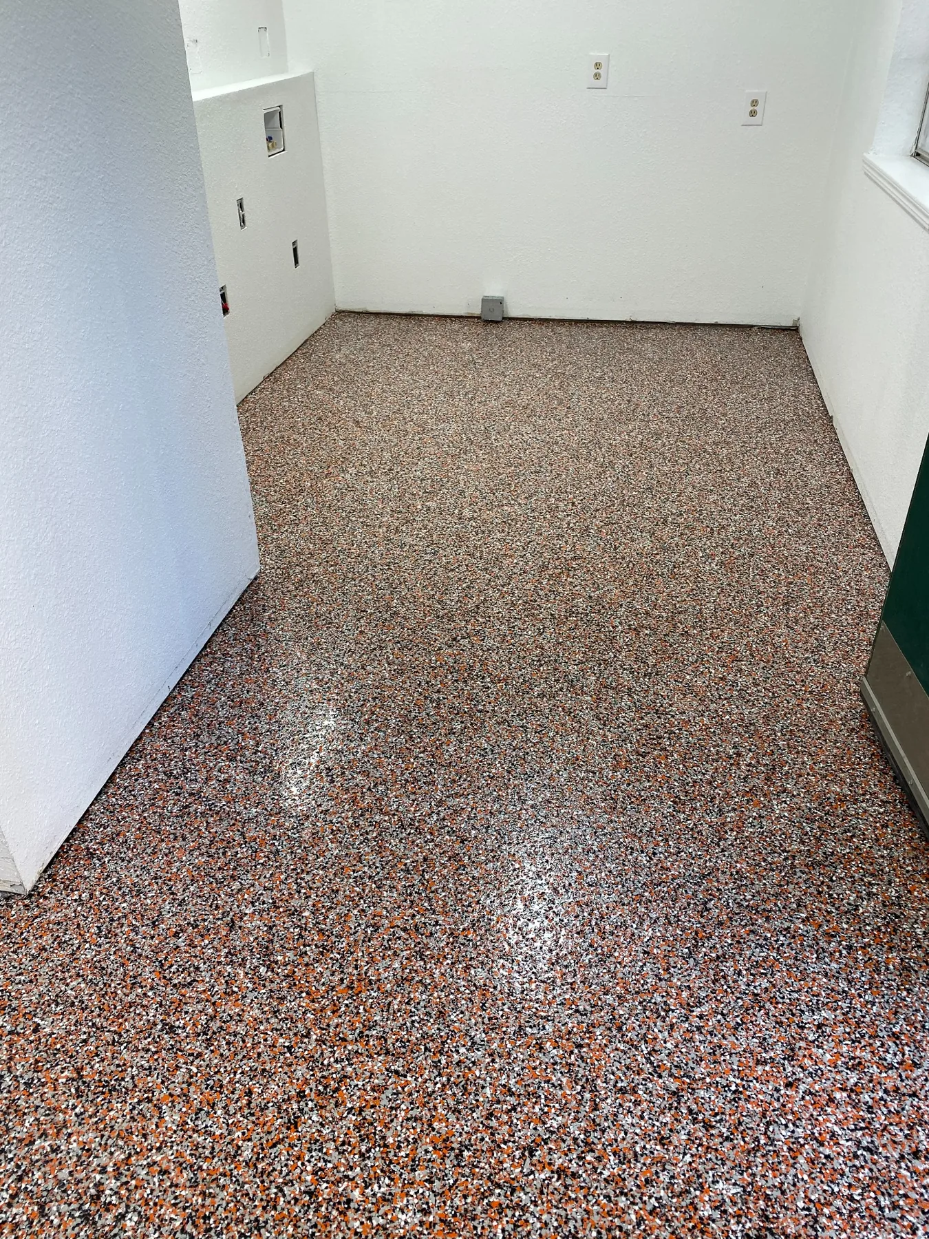 Finished orange, black and white epoxy flake floor